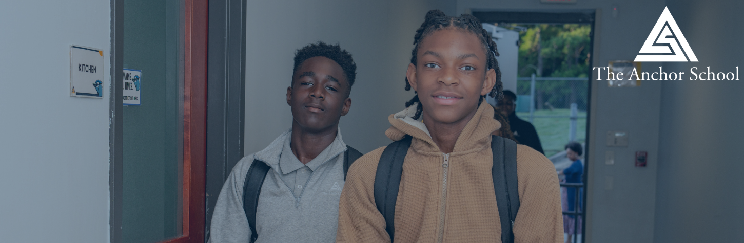 Two male students in school hallway