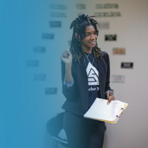 TAS teacher holding a clip board while teaching