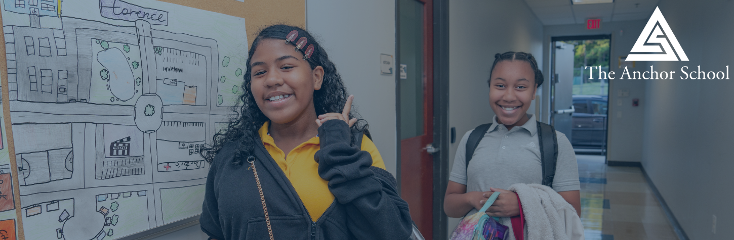Two female students walking in hallway with smiles