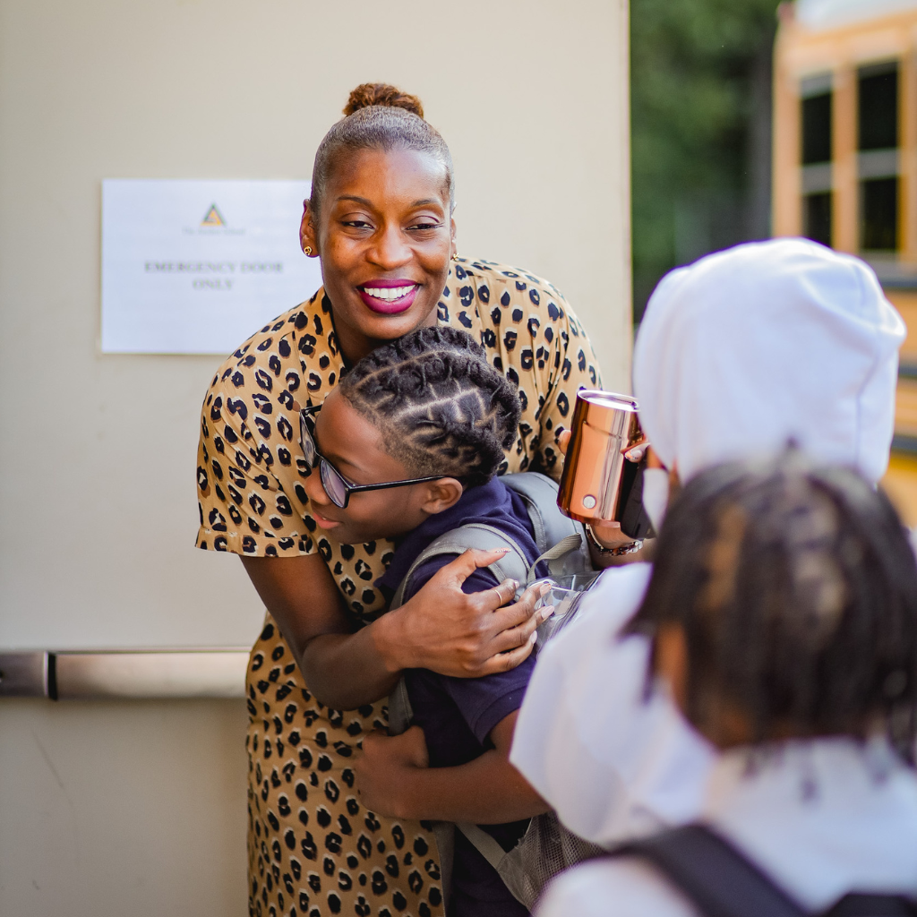 Anchor School teacher hugging a student